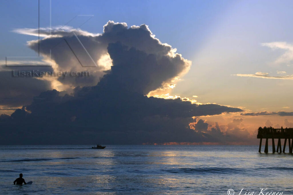 Photo of surfer at sunrise.