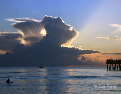 Photo of surfer at sunrise.